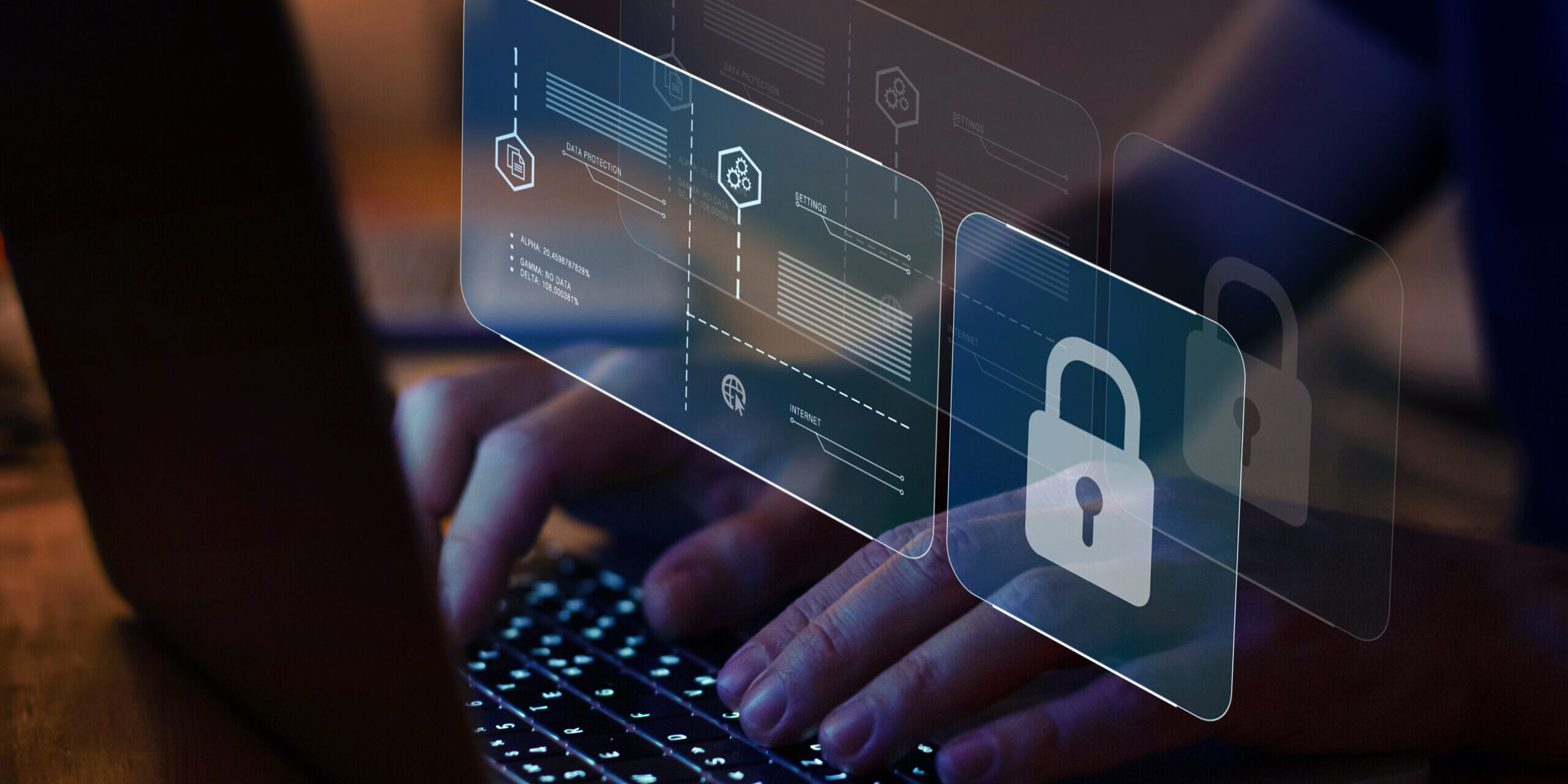 Cybersecurity in Action: Enhancing Protection Through Real-Time Monitoring Hands typing on a laptop keyboard with overlayed digital security icons, including padlocks and data protection graphics.