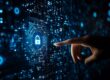 A digital representation of cybersecurity featuring a glowing lock icon within a circuit board design. A human finger is reaching towards the lock, symbolizing managed IT services protecting businesses from cyber threats.