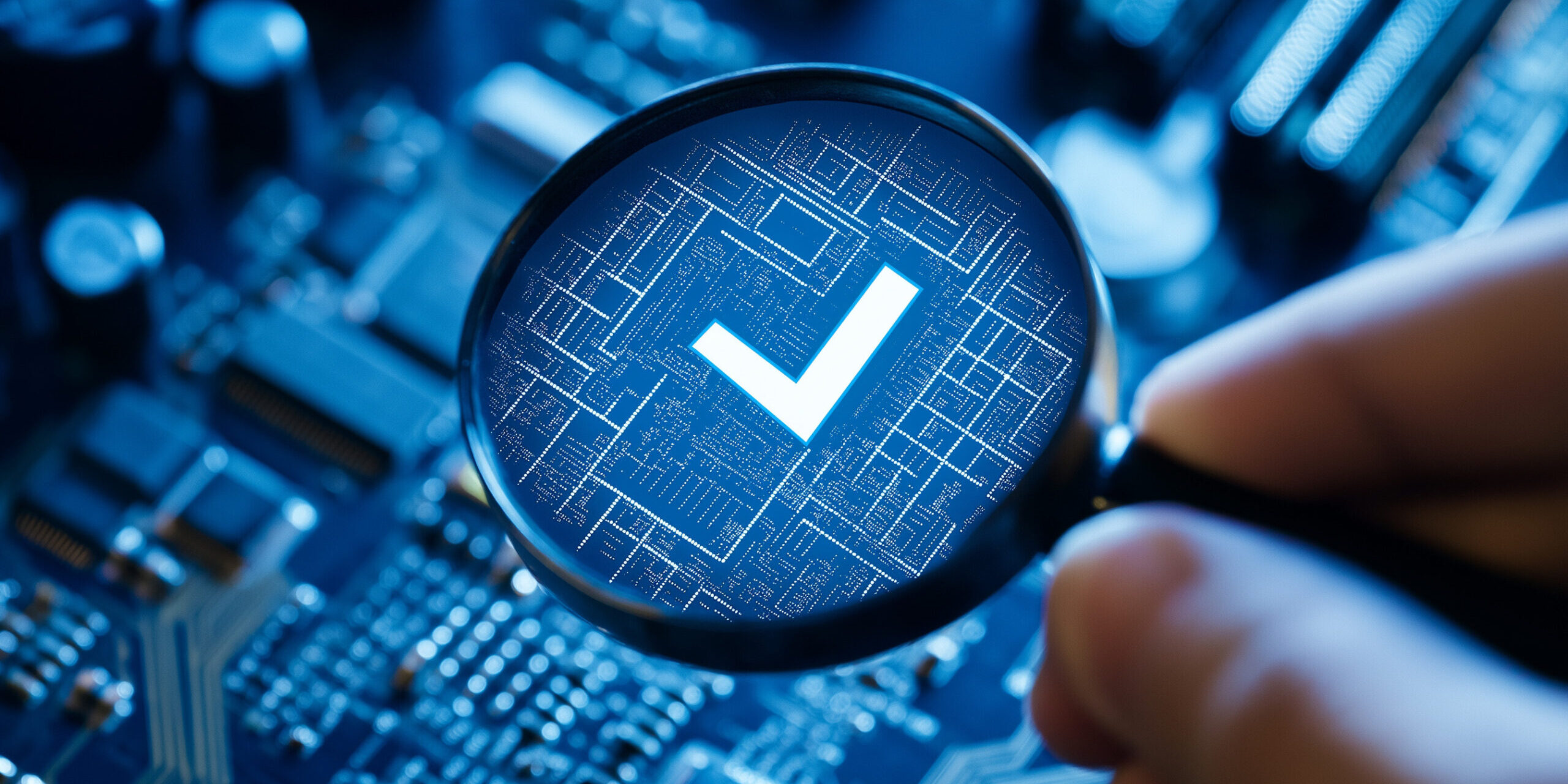 Verifying Hardware Compatibility for Windows 11 Upgrade Close-up of a magnifying glass over a computer circuit board showing a digital checkmark, symbolizing system readiness for Windows 11 upgrade