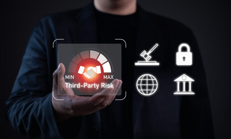 Business professional holding a digital icon representing third-party risk management with security, compliance, and governance symbols.