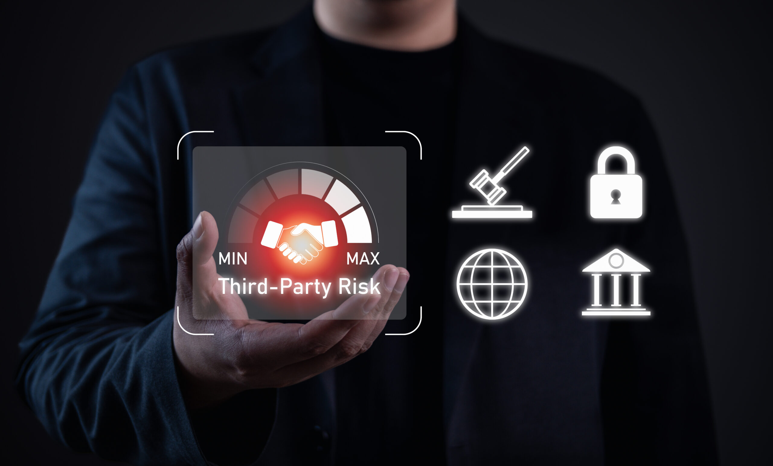 Business professional holding a digital icon representing third-party risk management with security, compliance, and governance symbols.