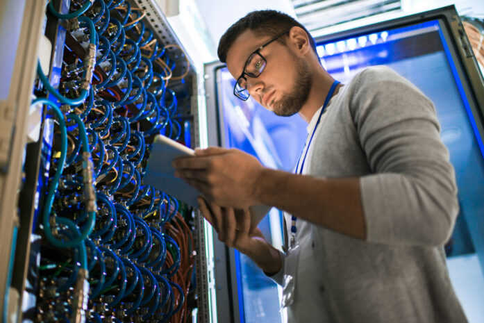 IT technician performing real-time network monitoring and maintenance as part of managed IT services for a small business