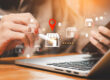 Business professional using a smartphone and laptop with digital location icons representing local businesses and the importance of local IT support for faster response times.