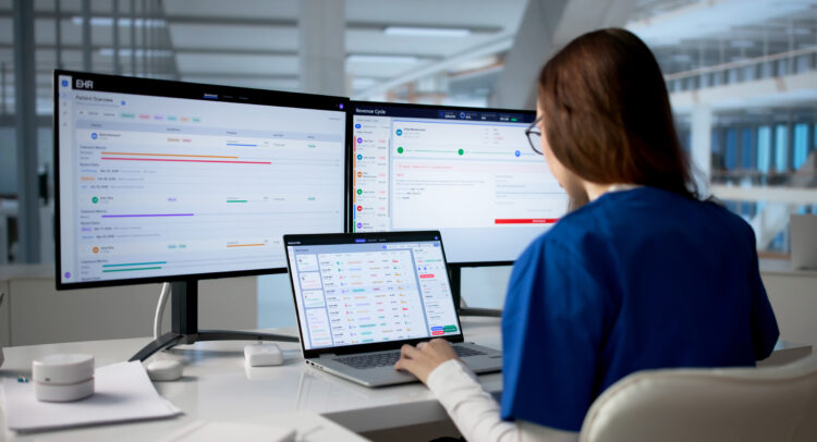 IT professional reviewing a documented network and business systems across multiple monitors, highlighting the importance of network documentation, network diagrams, and organized IT infrastructure for efficient management and disaster recovery.