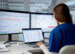 IT professional reviewing a documented network and business systems across multiple monitors, highlighting the importance of network documentation, network diagrams, and organized IT infrastructure for efficient management and disaster recovery.