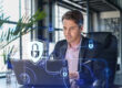 Business professional working on a laptop with cybersecurity icons and digital security overlays, illustrating common Microsoft 365 security mistakes and data protection best practices.