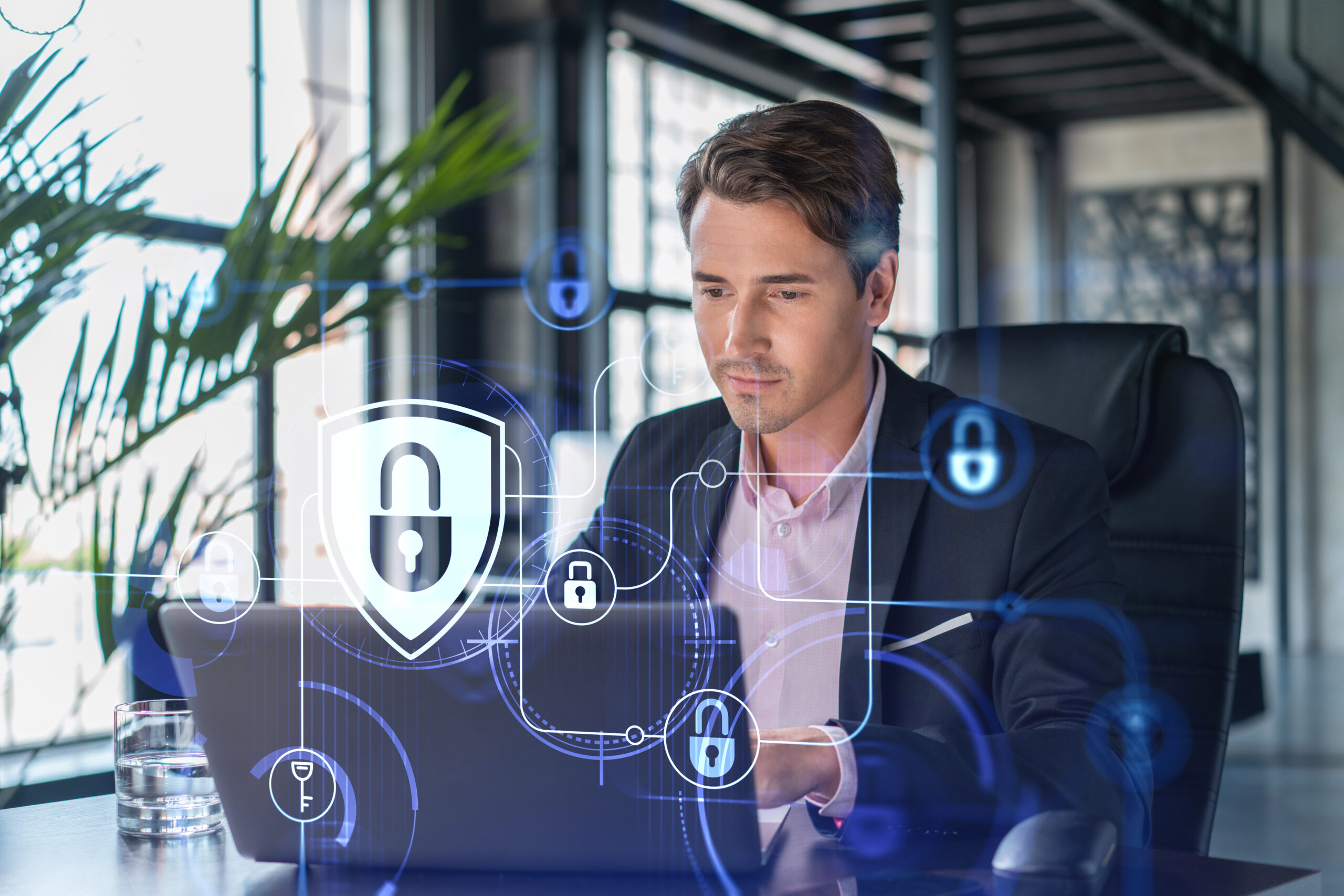 Business professional working on a laptop with cybersecurity icons and digital security overlays, illustrating common Microsoft 365 security mistakes and data protection best practices.